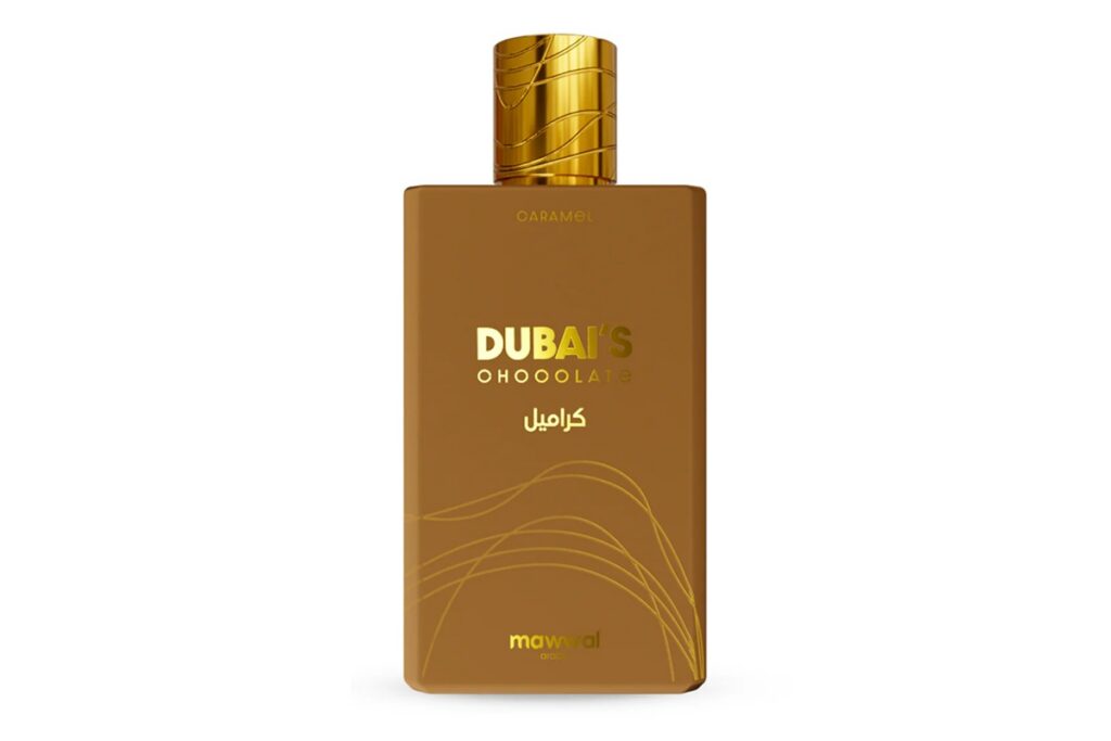 Frasco do perfume Dubai's Chocolate Caramel, em tom marrom com detalhes dourados e tampa metálica dourada.
